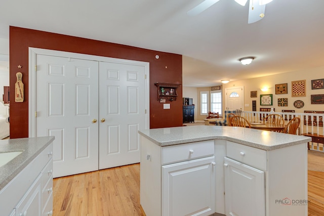 1538 Queen Ann Ln, Gurnee, IL 60031 - kitchen featuring light wood-style flooring, a center island, ceiling fan, white cabinetry, and open floor plan