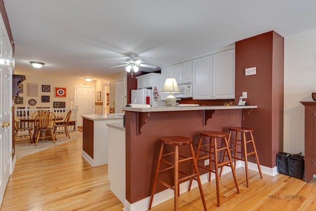 1538 Queen Ann Ln, Gurnee, IL 60031 - kitchen with white appliances, a ceiling fan, a peninsula, and light wood-style floors