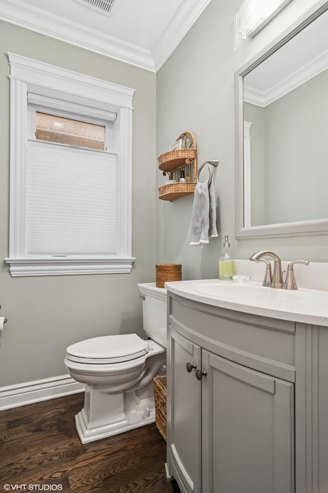 4130 N Mango Ave, Chicago, IL 60634 - half bathroom with wood finished floors, vanity, and ornamental molding