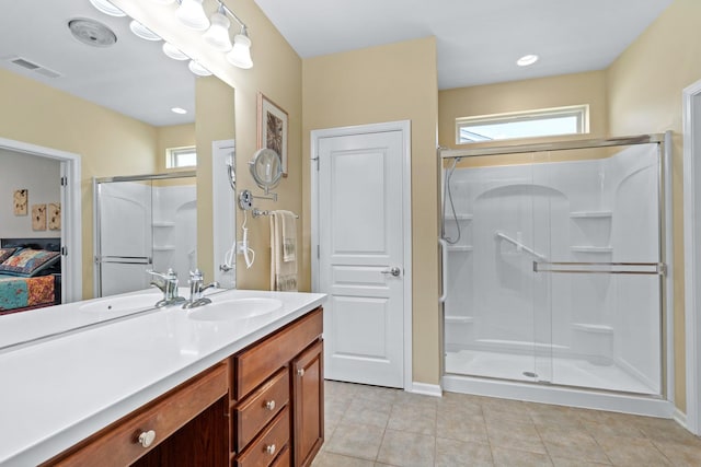 3251 Ravinia Cir, Mundelein, IL 60060 - ensuite bathroom featuring a stall shower, vanity, tile patterned floors, and plenty of natural light