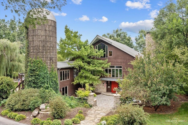 51 Chippewa Dr, Oswego, IL 60543 - view of front of home featuring a chimney and a metal roof