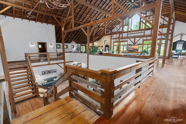 51 Chippewa Dr, Oswego, IL 60543 - stairway featuring high vaulted ceiling, wood-type flooring, and beam ceiling