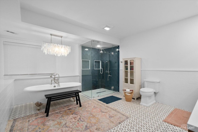 51 Chippewa Dr, Oswego, IL 60543 - full bathroom with a shower stall, a freestanding bath, wainscoting, tile patterned floors, and a chandelier