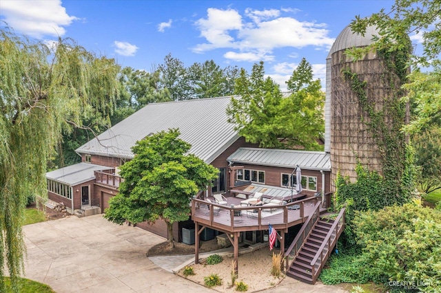 51 Chippewa Dr, Oswego, IL 60543 - back of house with stairs, a deck, a metal roof, driveway, and a standing seam roof