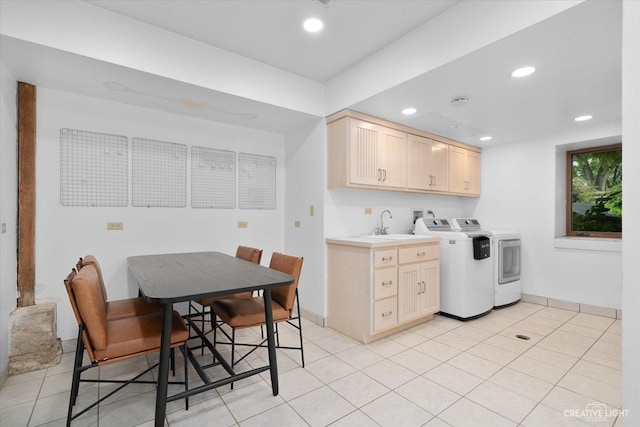 51 Chippewa Dr, Oswego, IL 60543 - kitchen with washing machine and dryer, recessed lighting, light brown cabinetry, light tile patterned floors, and light countertops