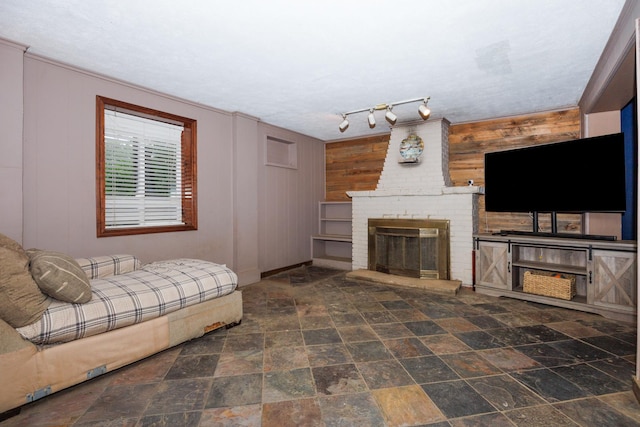 17366 Walden Rd, Hudson, IL 61748 - living room with a fireplace, wooden walls, and stone finish flooring