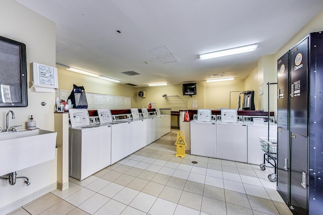 30 E Huron St Unit 2603, Chicago, IL 60611 - shared laundry with separate washer and dryer and light tile patterned flooring