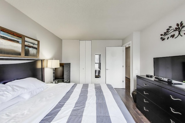 30 E Huron St Unit 2603, Chicago, IL 60611 - bedroom featuring dark wood-type flooring, a closet, and a textured ceiling