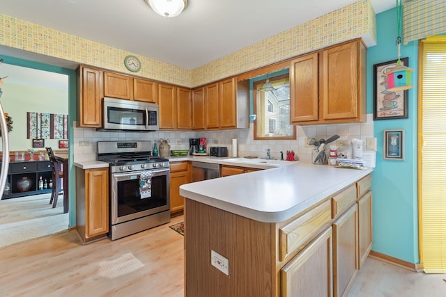 255 Ironbark Ct, Bolingbrook, IL 60440 - kitchen featuring stainless steel appliances, light countertops, a peninsula, and tasteful backsplash