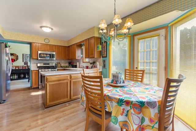 255 Ironbark Ct, Bolingbrook, IL 60440 - dining space with a chandelier, light wood finished floors, and plenty of natural light