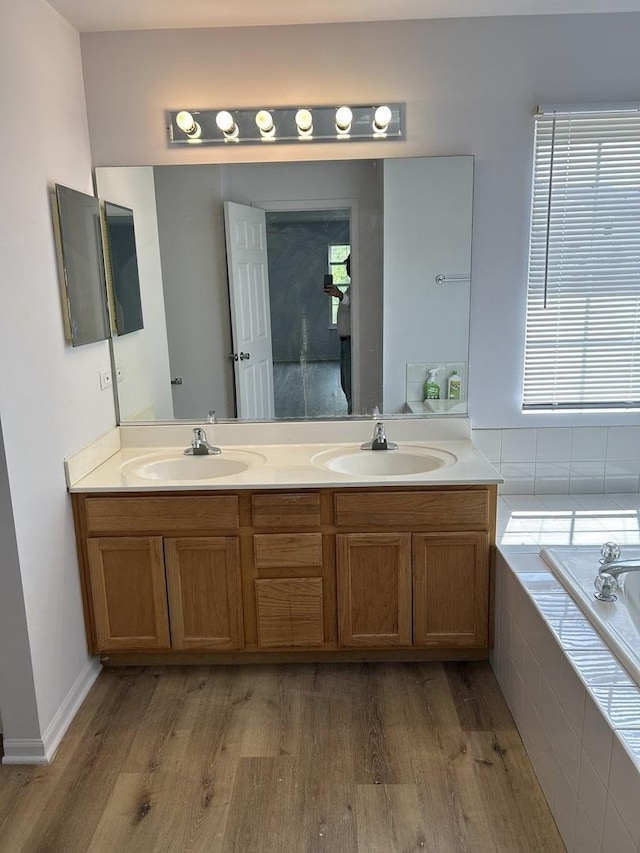 161 Gregory M Sears Dr, Gilberts, IL 60136 - full bathroom with wood finished floors, double vanity, and a garden tub