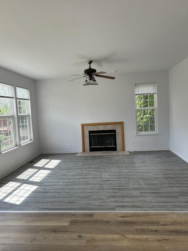 161 Gregory M Sears Dr, Gilberts, IL 60136 - unfurnished living room featuring healthy amount of natural light, a ceiling fan, wood finished floors, and a premium fireplace