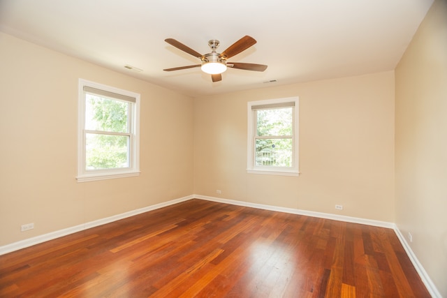 2900 W Birchwood Ave, Chicago, IL 60645 - empty room with plenty of natural light, dark wood-style flooring, and a ceiling fan