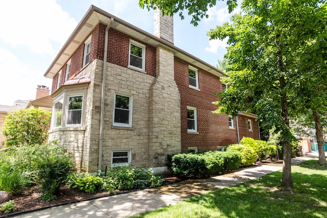 2900 W Birchwood Ave, Chicago, IL 60645 - view of property exterior with stone siding and a chimney