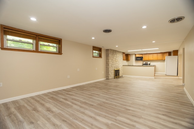 2900 W Birchwood Ave, Chicago, IL 60645 - unfurnished living room with recessed lighting, light wood-style floors, and a stone fireplace