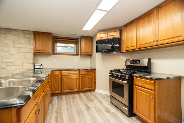 2900 W Birchwood Ave, Chicago, IL 60645 - kitchen with gas stove, black microwave, and brown cabinetry