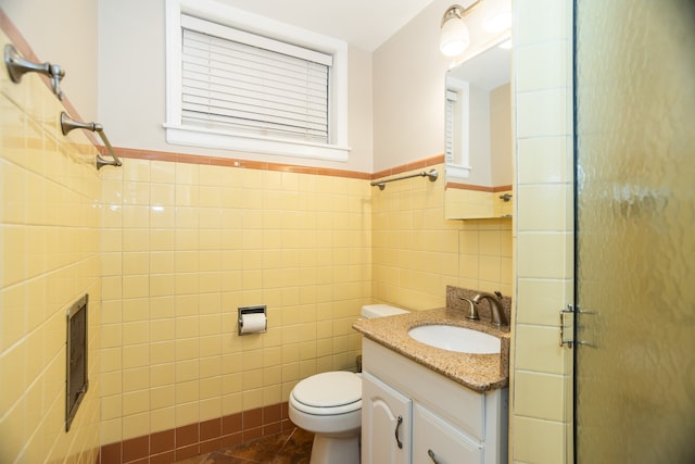 2900 W Birchwood Ave, Chicago, IL 60645 - bathroom featuring tile walls, vanity, a shower with shower door, and wainscoting