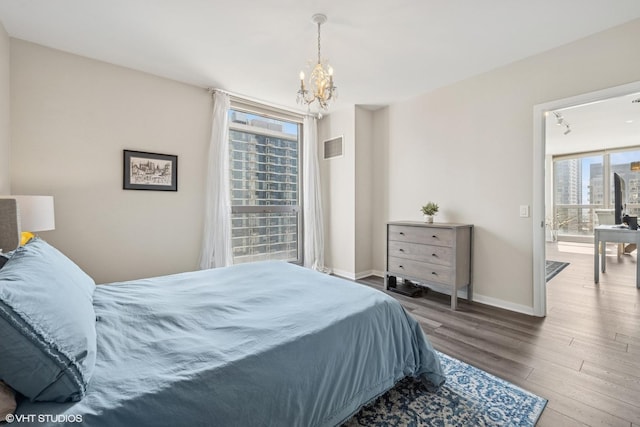 200 W Grand Ave Unit 1803, Chicago, IL 60654 - bedroom with a chandelier, multiple windows, and wood finished floors