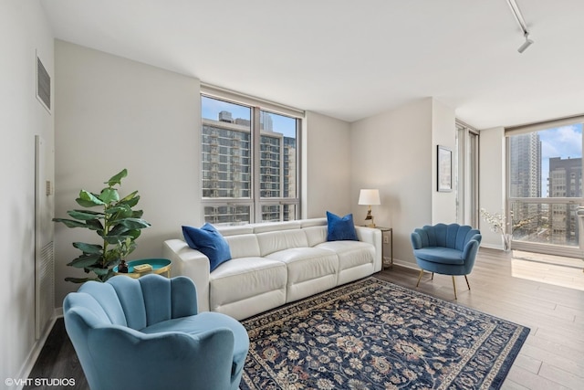 200 W Grand Ave Unit 1803, Chicago, IL 60654 - living room with healthy amount of natural light, a view of city, wood finished floors, floor to ceiling windows, and rail lighting