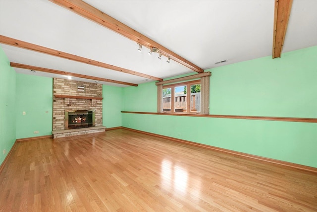 8410 S 78th Ave, Bridgeview, IL 60455 - unfurnished living room with beamed ceiling, wood finished floors, and a brick fireplace