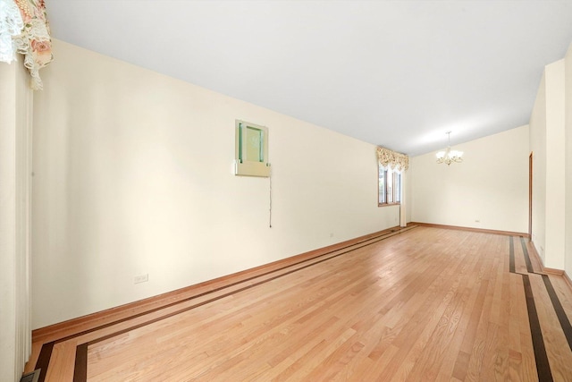 8410 S 78th Ave, Bridgeview, IL 60455 - spare room featuring a chandelier, light wood-style flooring, and lofted ceiling