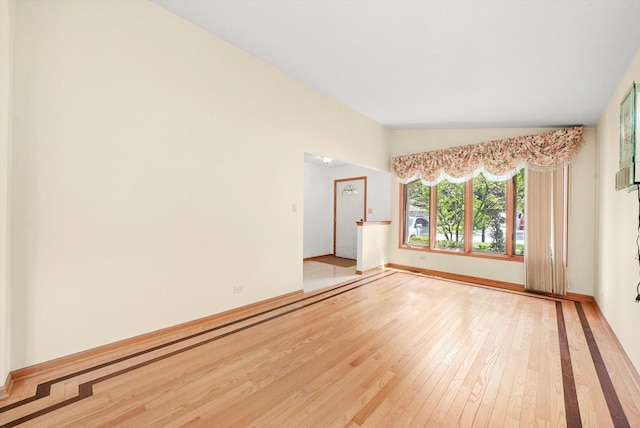 8410 S 78th Ave, Bridgeview, IL 60455 - spare room featuring hardwood / wood-style flooring and vaulted ceiling