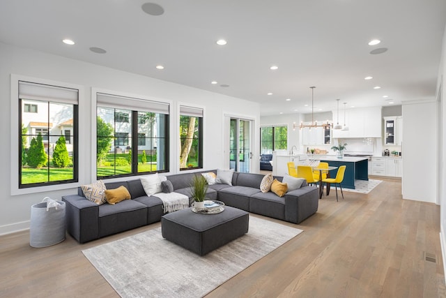 834 Wellner Rd, Naperville, IL 60540 - living area featuring recessed lighting, light wood-style floors, and a chandelier