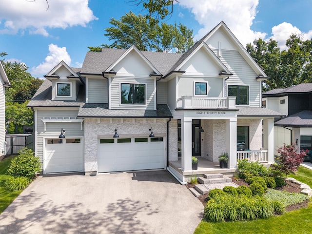 834 Wellner Rd, Naperville, IL 60540 - view of front of property featuring covered porch, a shingled roof, asphalt driveway, and a garage