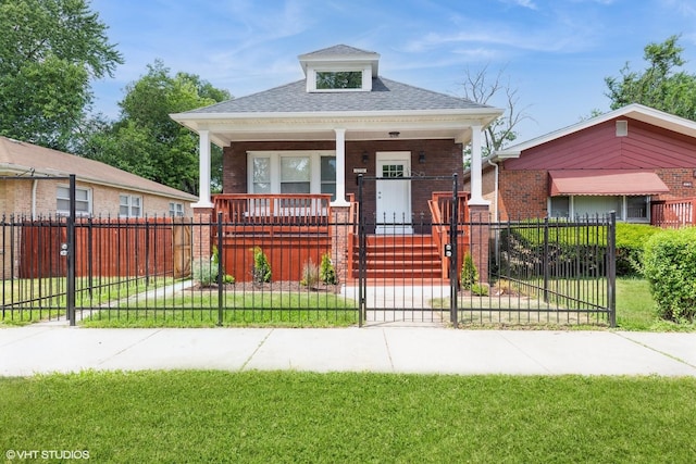 12330 S Perry Ave, Chicago, IL 60628 - view of front of home featuring covered porch, brick siding, a gate, a shingled roof, and a fenced front yard