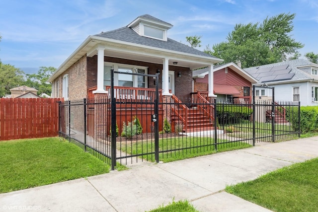 12330 S Perry Ave, Chicago, IL 60628 - view of front facade with a porch, brick siding, a shingled roof, a fenced front yard, and a gate