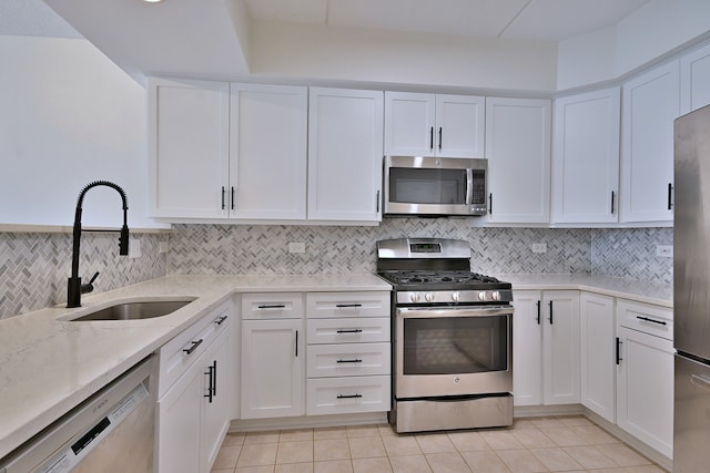 111 N Larch Ave Unit 206, Elmhurst, IL 60126 - kitchen with stainless steel appliances, light stone counters, white cabinets, and backsplash