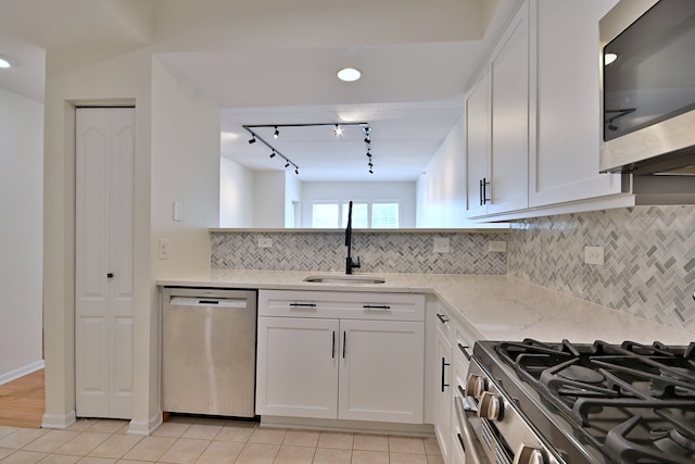 111 N Larch Ave Unit 206, Elmhurst, IL 60126 - kitchen with stainless steel appliances, track lighting, light tile patterned flooring, light stone counters, and white cabinetry