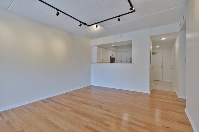 111 N Larch Ave Unit 206, Elmhurst, IL 60126 - unfurnished living room with track lighting, light wood finished floors, a garage, and recessed lighting