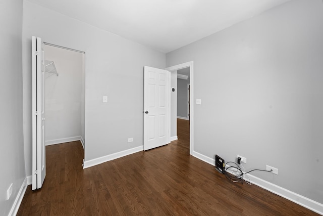 4604 N Monticello Ave Unit 3E, Chicago, IL 60625 - unfurnished bedroom featuring dark wood-type flooring, a walk in closet, and a closet