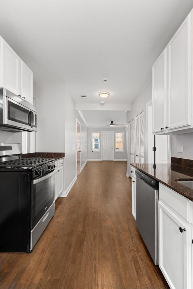 4604 N Monticello Ave Unit 3E, Chicago, IL 60625 - kitchen featuring stainless steel appliances, dark wood-style flooring, white cabinets, and a ceiling fan