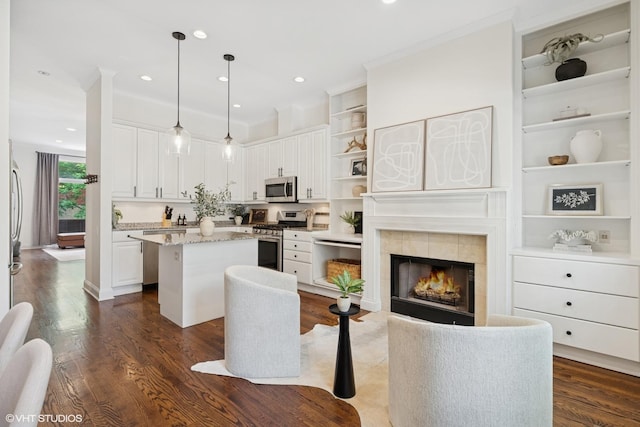 1401 N Wieland St Unit P, Chicago, IL 60610 - kitchen featuring appliances with stainless steel finishes, open shelves, a kitchen island, white cabinets, and dark wood-style floors