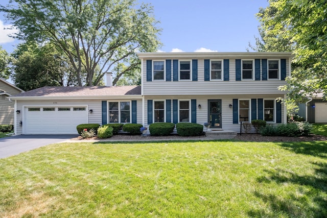 674 Carriage Dr, Batavia, IL 60510 - colonial inspired home with asphalt driveway, an attached garage, and a front lawn