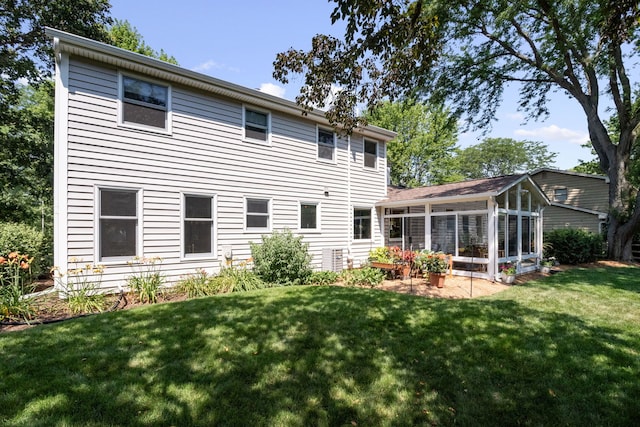674 Carriage Dr, Batavia, IL 60510 - back of house with a sunroom and a lawn