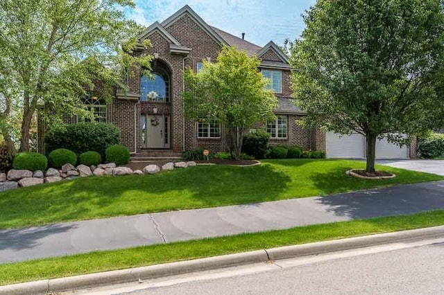 12499 Ayrshire Ln, Loves Park, IL 61111 - traditional-style home with brick siding, concrete driveway, a garage, and a front lawn