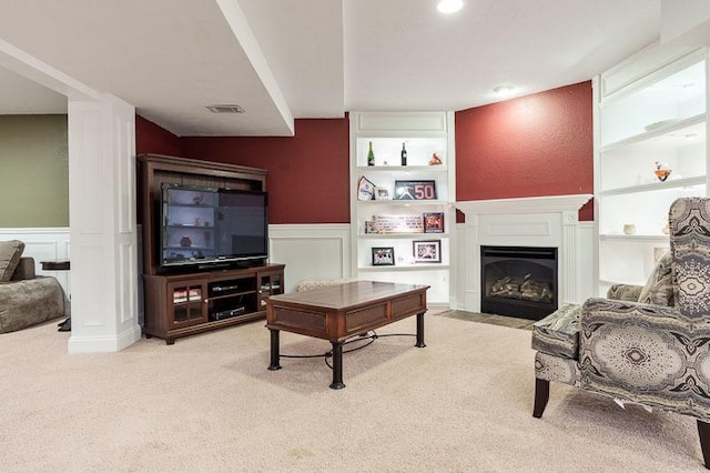 12499 Ayrshire Ln, Loves Park, IL 61111 - living area featuring carpet flooring, a wainscoted wall, a decorative wall, and a fireplace with flush hearth