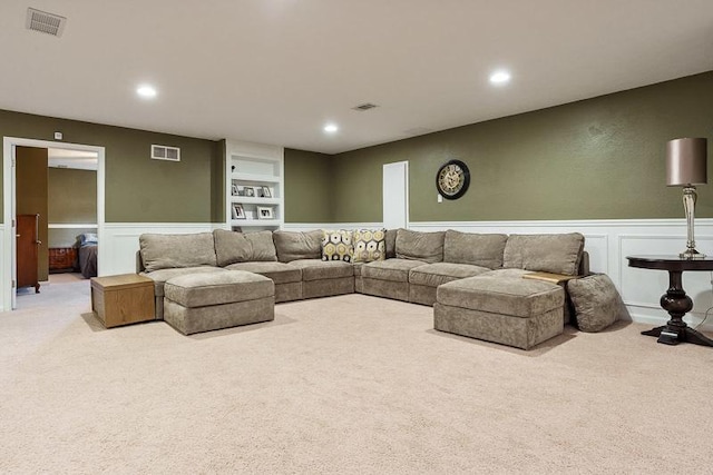 12499 Ayrshire Ln, Loves Park, IL 61111 - carpeted living area with a decorative wall, wainscoting, and recessed lighting