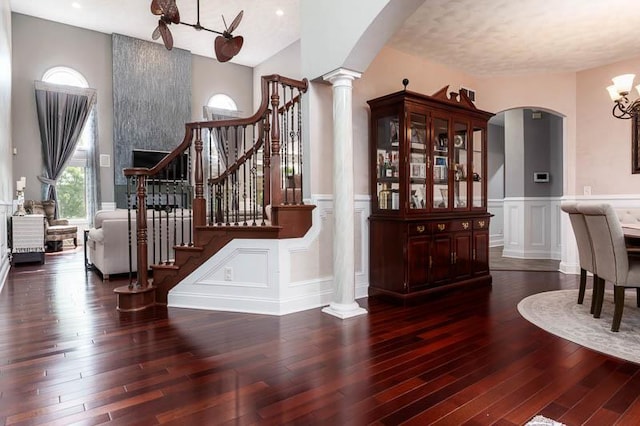 12499 Ayrshire Ln, Loves Park, IL 61111 - foyer entrance with ornate columns, arched walkways, a chandelier, a decorative wall, and hardwood / wood-style flooring