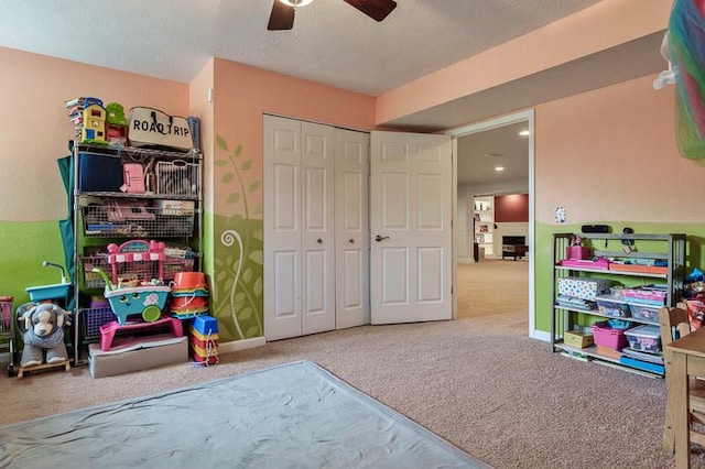 12499 Ayrshire Ln, Loves Park, IL 61111 - rec room with carpet, a ceiling fan, and a textured ceiling