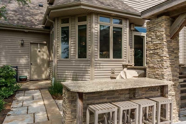 12499 Ayrshire Ln, Loves Park, IL 61111 - doorway to property featuring a shingled roof