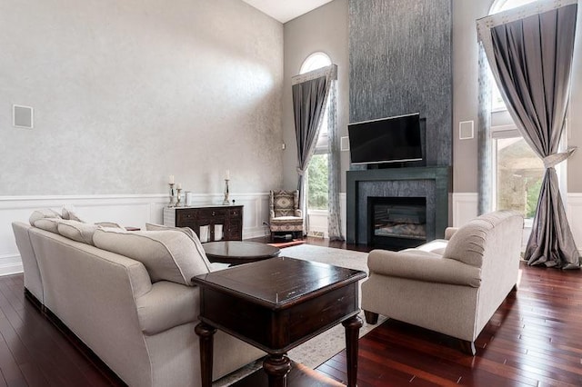 12499 Ayrshire Ln, Loves Park, IL 61111 - living room featuring dark wood finished floors, wainscoting, and a large fireplace