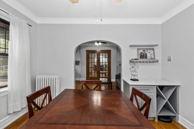 510 Madison St Unit 3S, Oak Park, IL 60302 - dining room featuring arched walkways, radiator, ceiling fan, wood finished floors, and ornamental molding