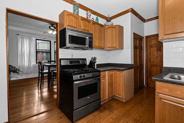 510 Madison St Unit 3S, Oak Park, IL 60302 - kitchen featuring appliances with stainless steel finishes, crown molding, dark countertops, and dark wood finished floors