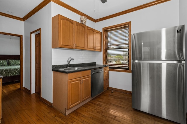 510 Madison St Unit 3S, Oak Park, IL 60302 - kitchen featuring stainless steel appliances, crown molding, tasteful backsplash, dark wood-style flooring, and dark countertops