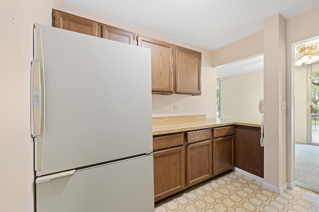 1150 E Jackson St Unit 1A, Lombard, IL 60148 - kitchen with freestanding refrigerator, light countertops, light floors, and healthy amount of natural light