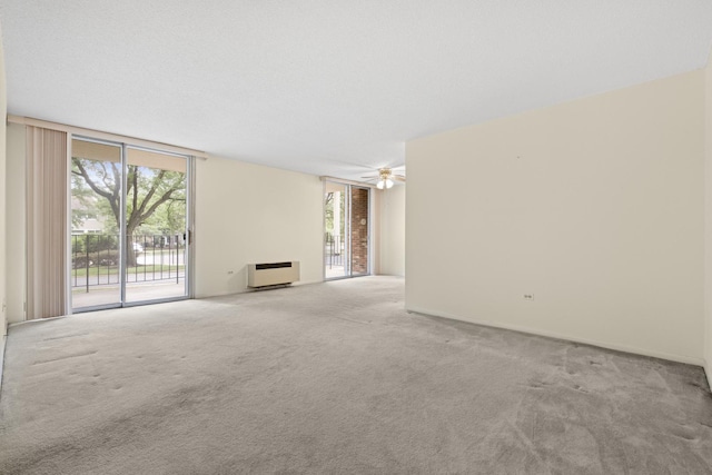 1150 E Jackson St Unit 1A, Lombard, IL 60148 - unfurnished living room with carpet, floor to ceiling windows, plenty of natural light, and a ceiling fan